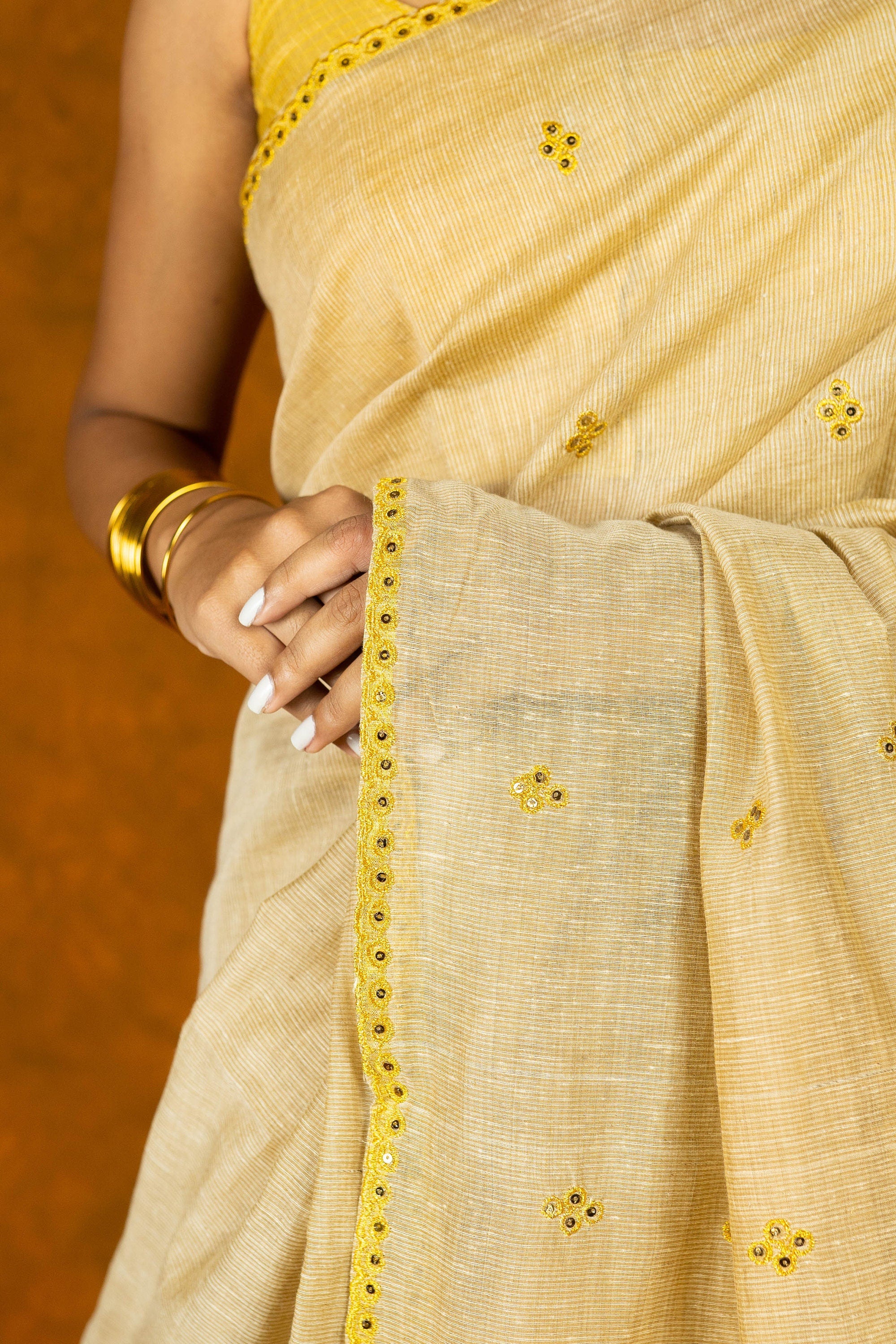 Beige and yellow gold zari embroidery saree