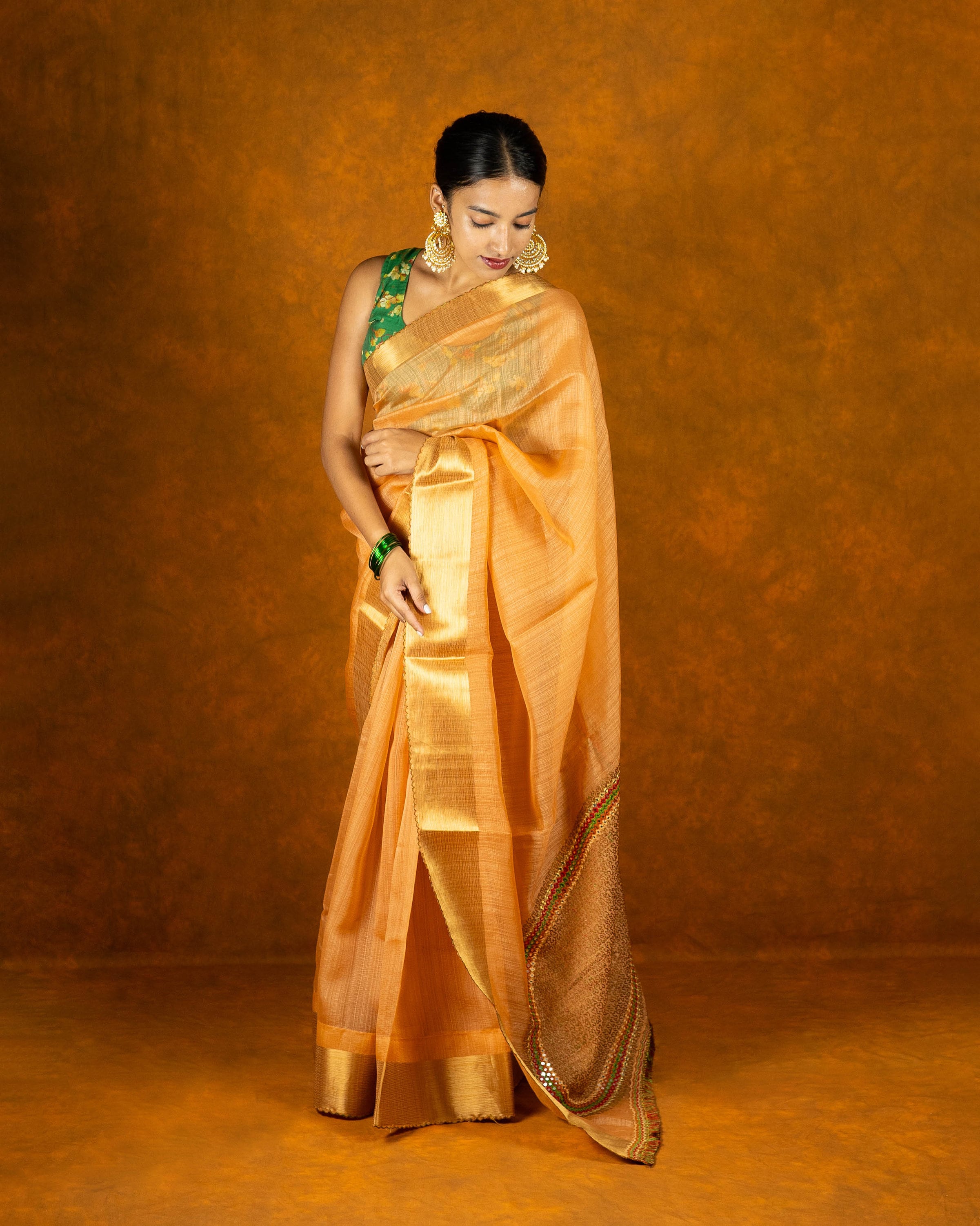 Peach Orange embroidery mirror-work saree with gold border and tassels