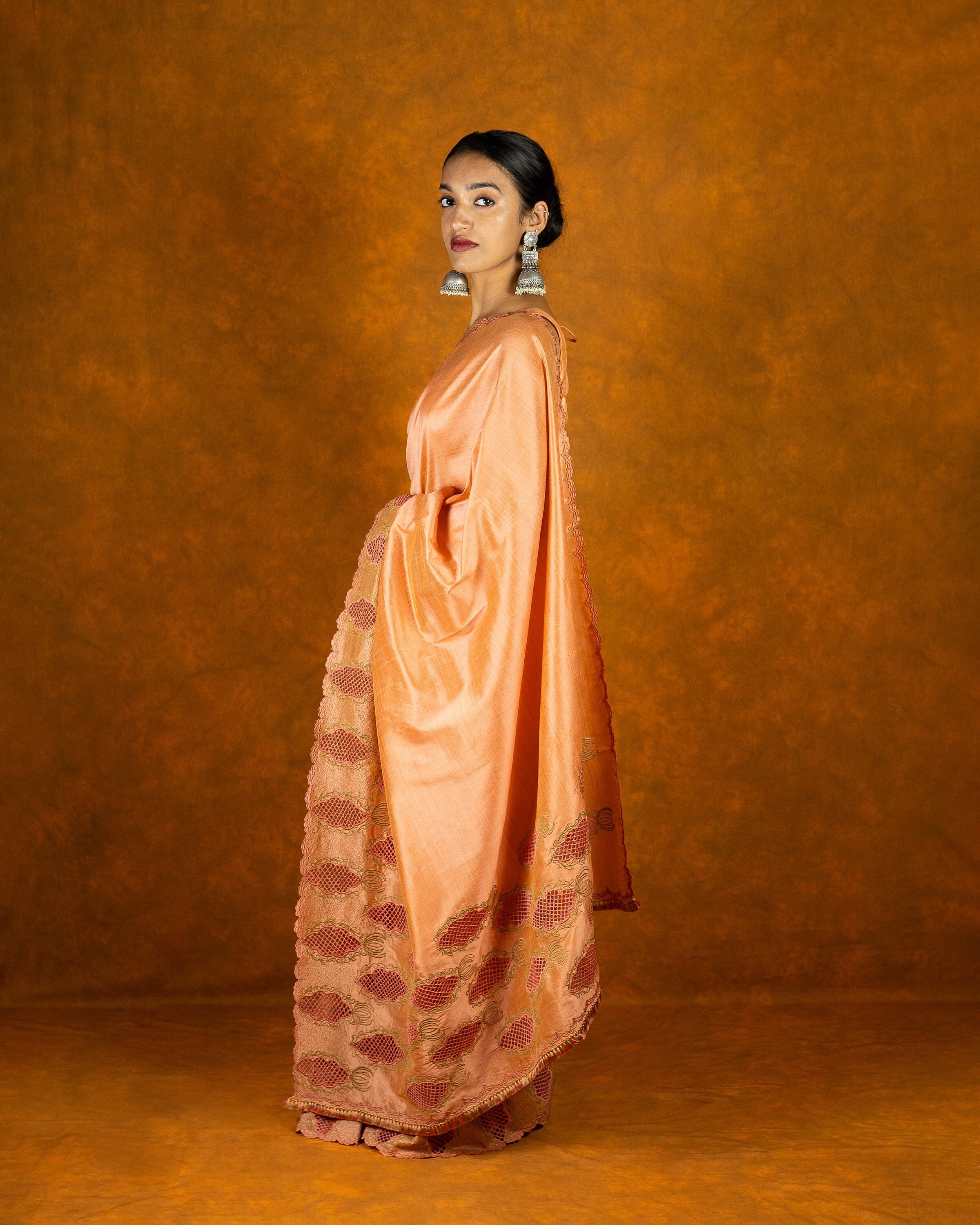 Peach cutwork embroidery saree with tassels