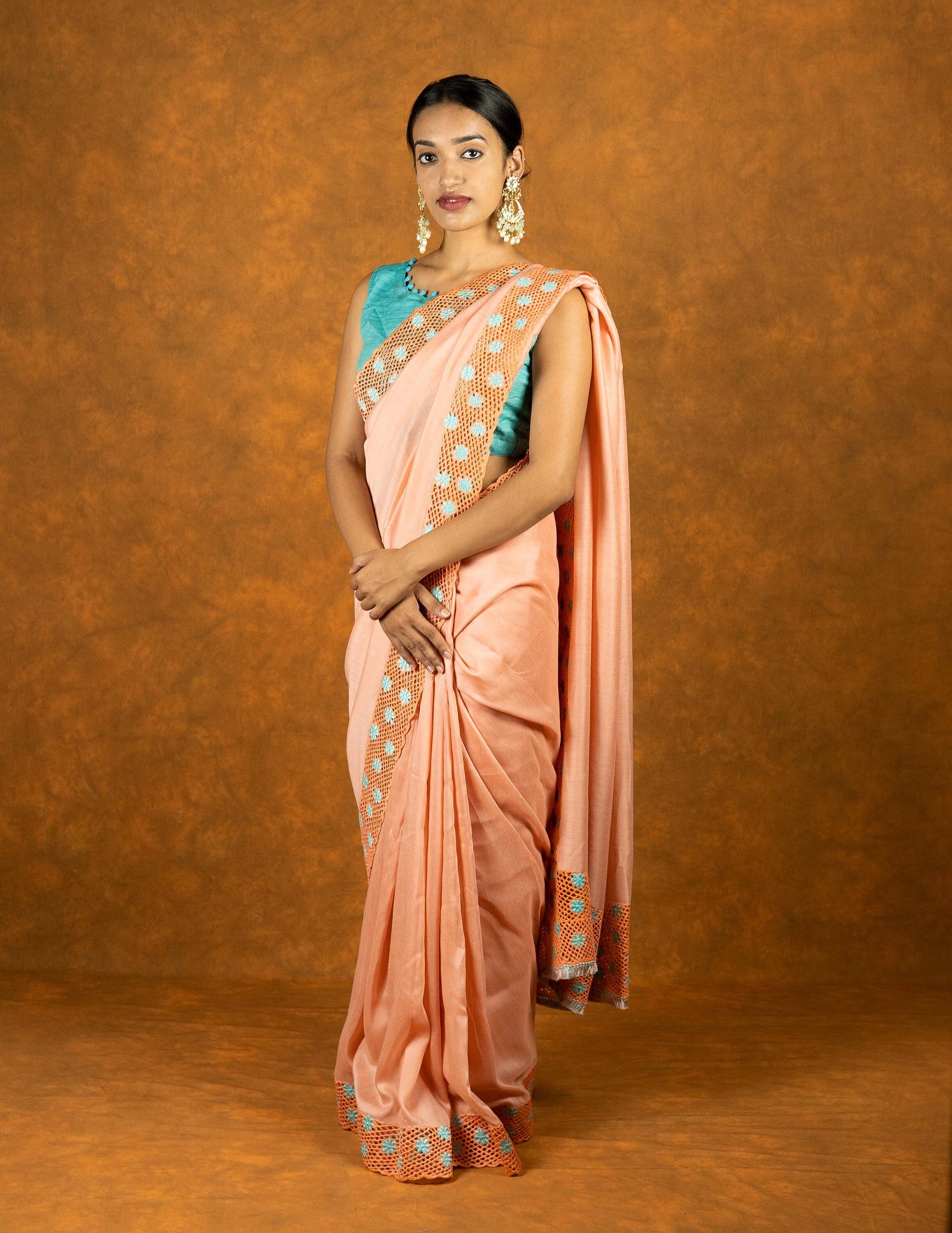 Peach chinnon silk cutwork embroidered saree with tassels