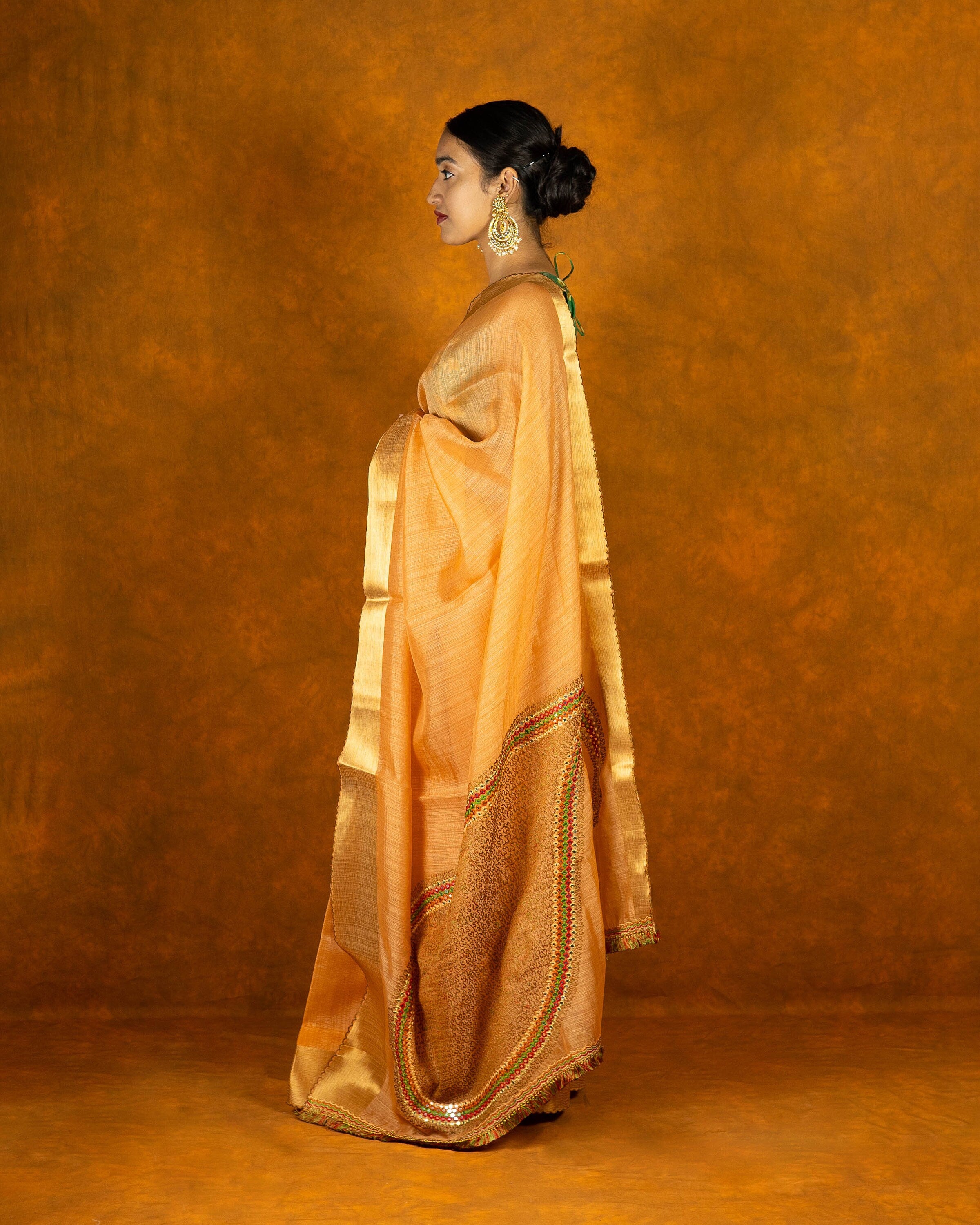 Peach Orange embroidery mirror-work saree with gold border and tassels