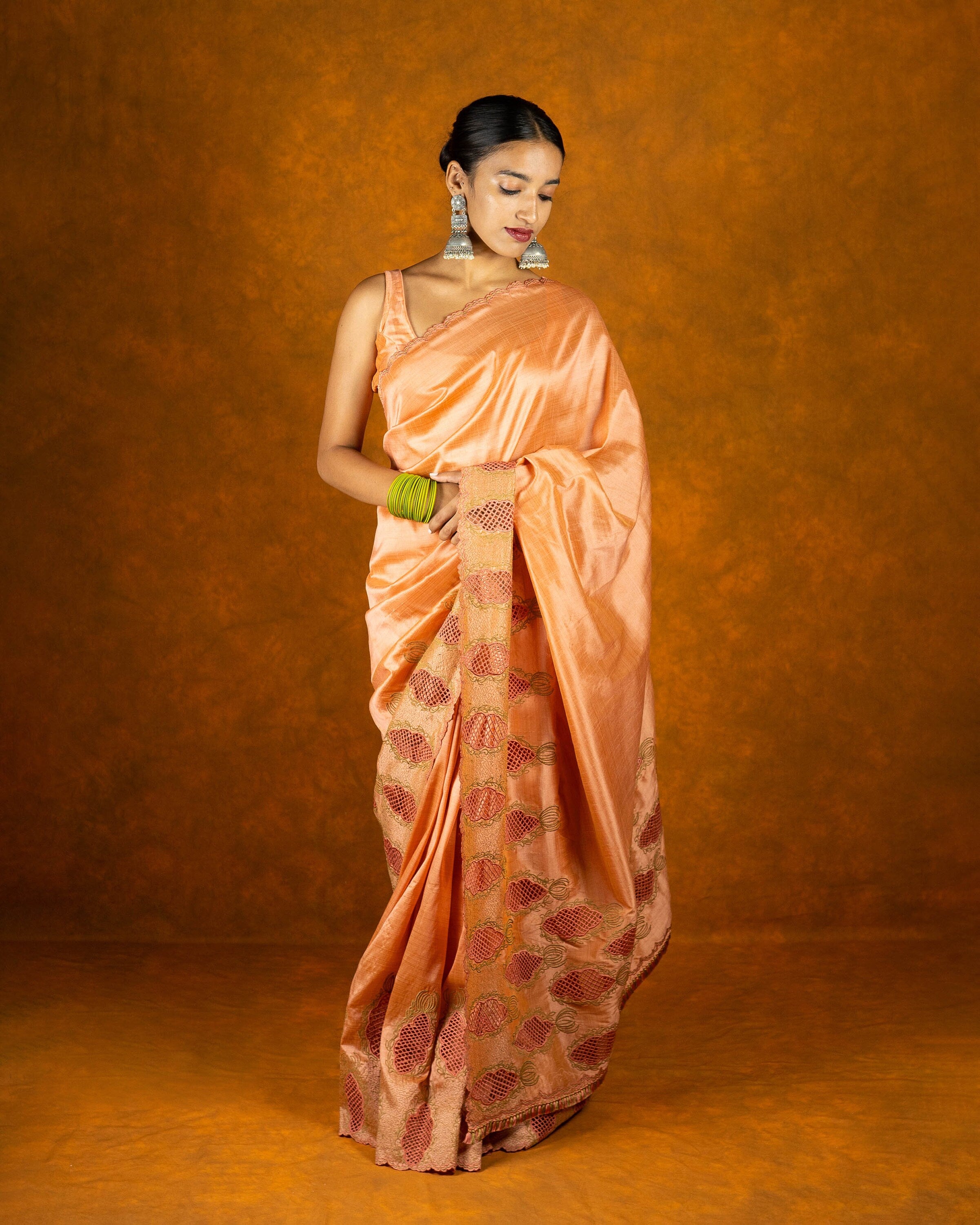 Peach cutwork embroidery saree with tassels