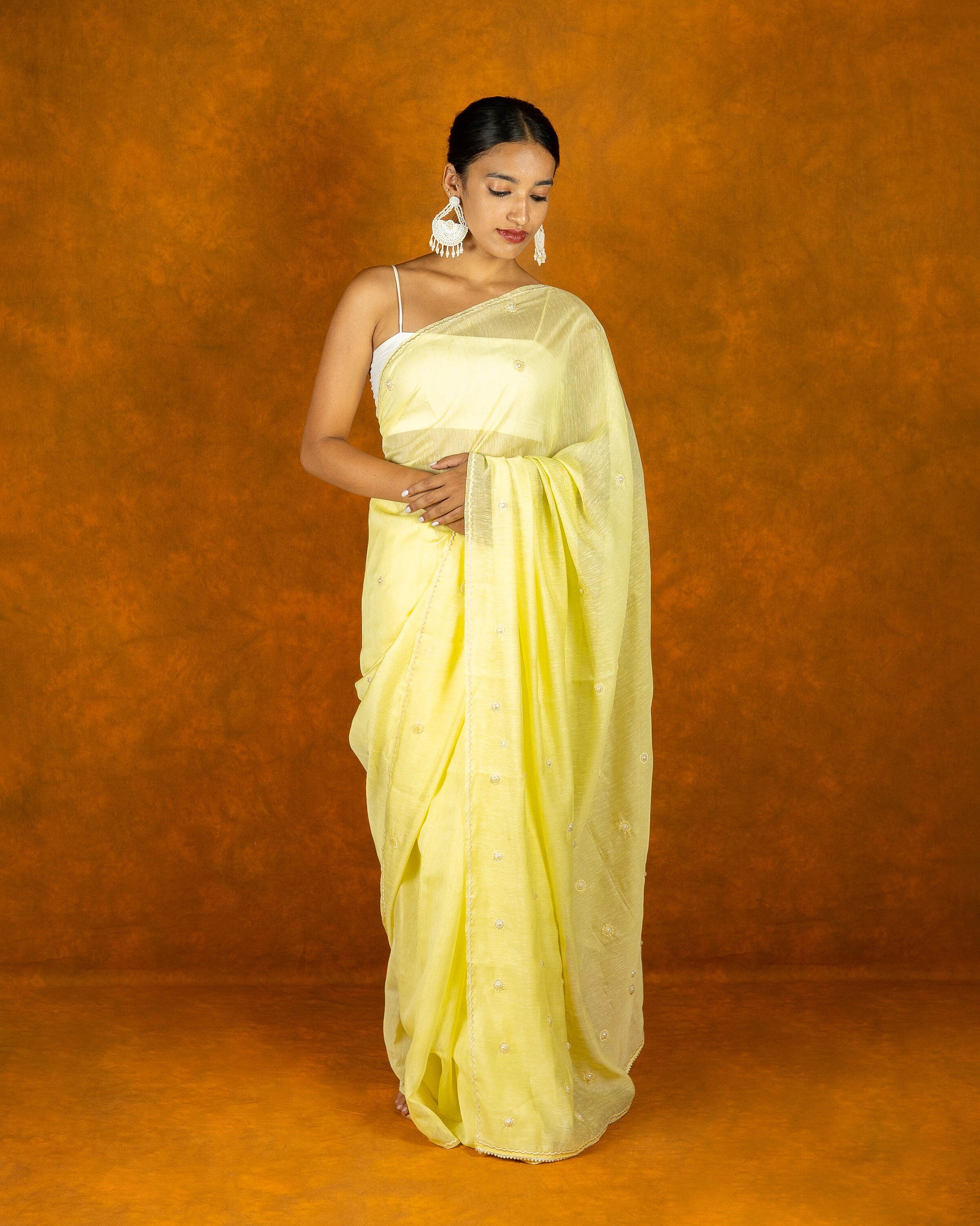 Lemon yellow linen saree with pearl work,
