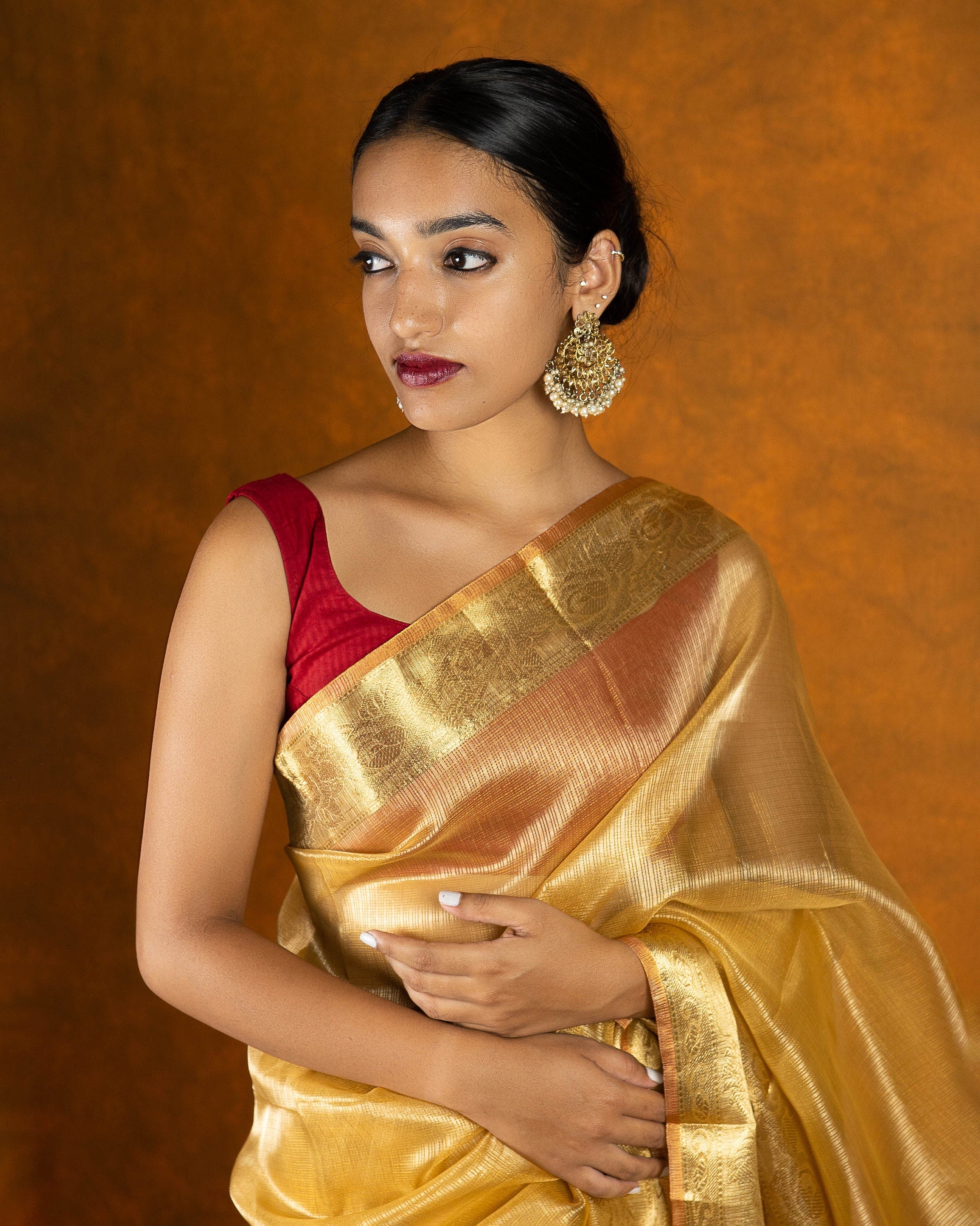 Gold jute silk saree with stone work border and tassel
