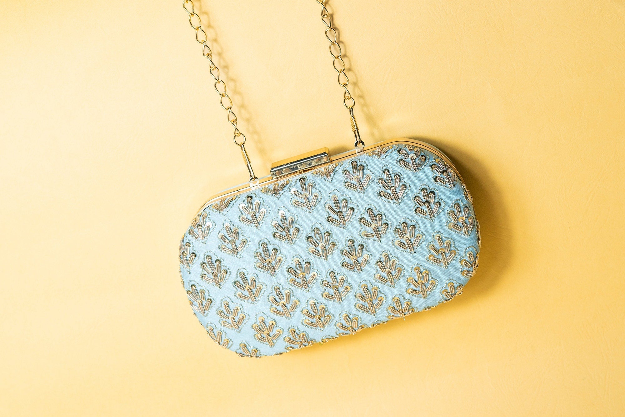 Powder blue metal embroidery clutch bag with detachable sling