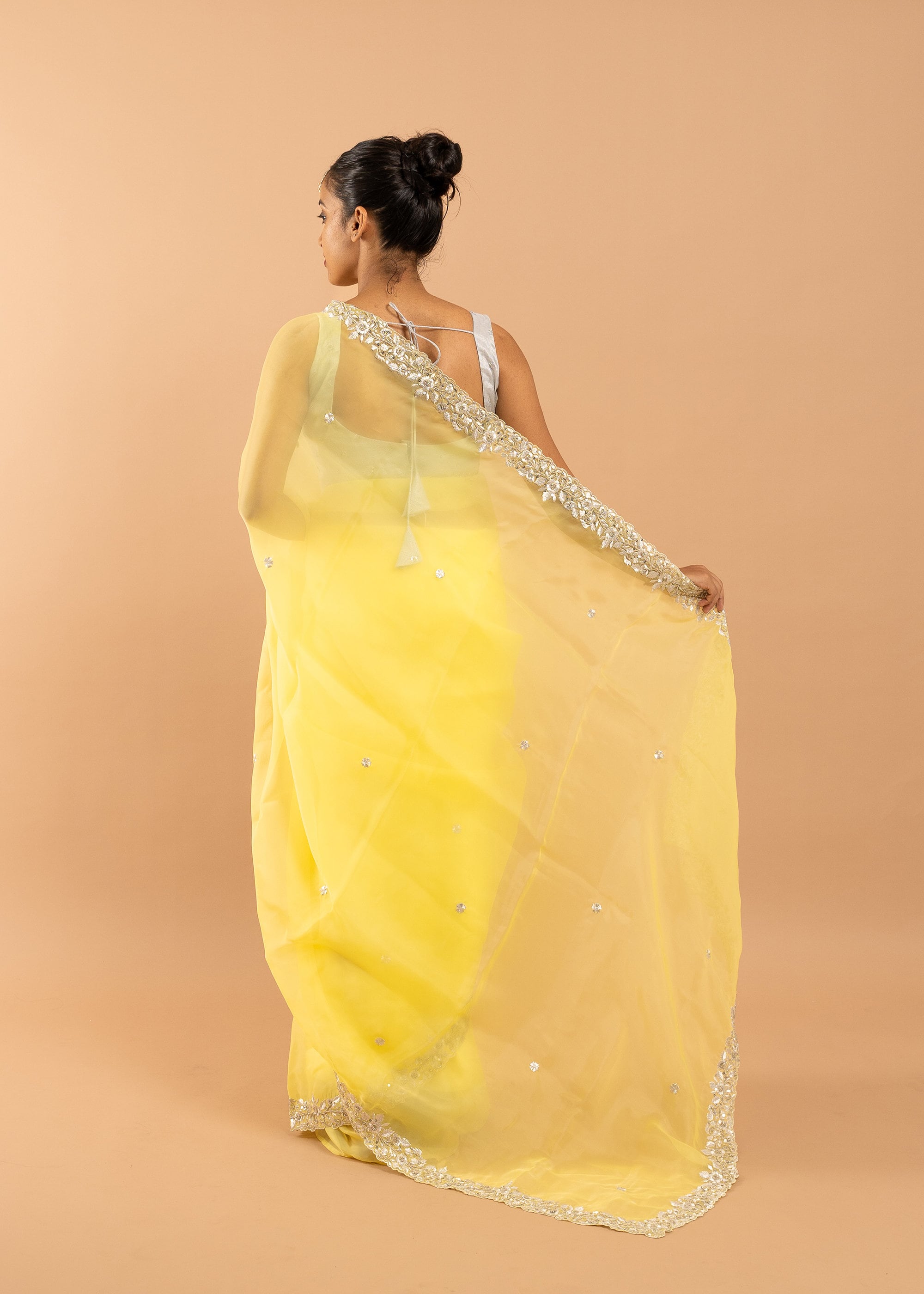 Yellow organza saree with zari silk thread and beads handwork embroidery