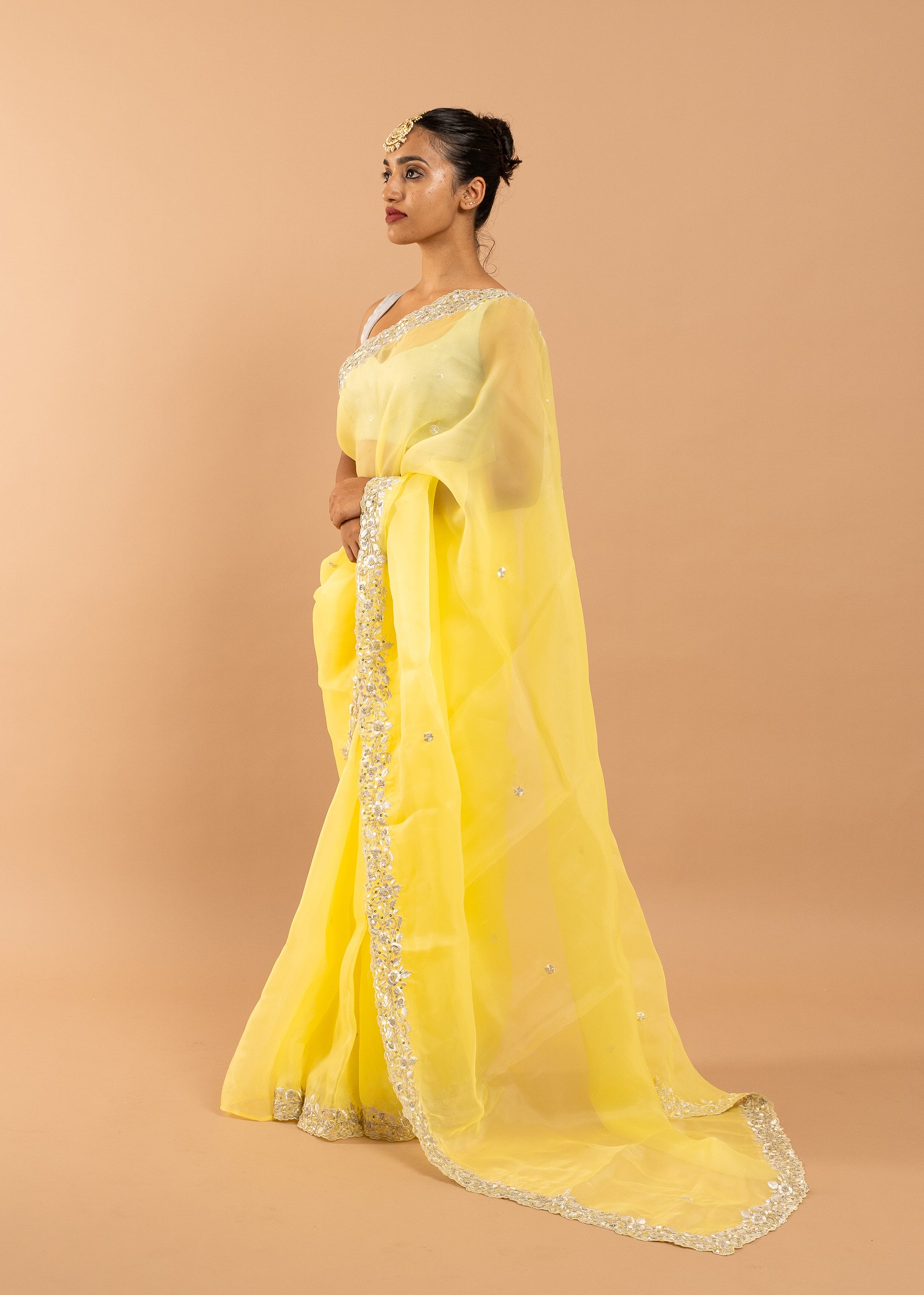 Yellow organza saree with zari silk thread and beads handwork embroidery