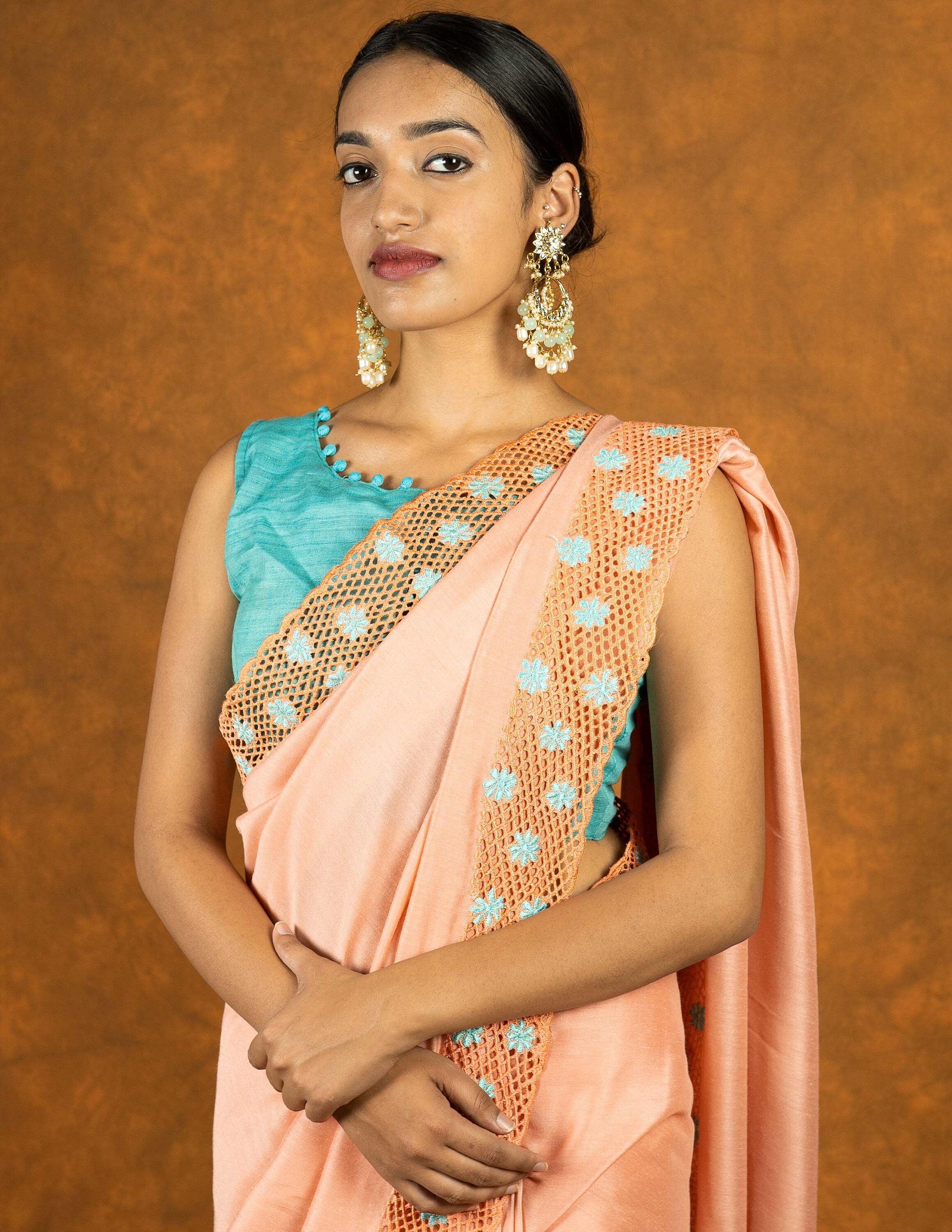 Peach chinnon silk cutwork embroidered saree with tassels