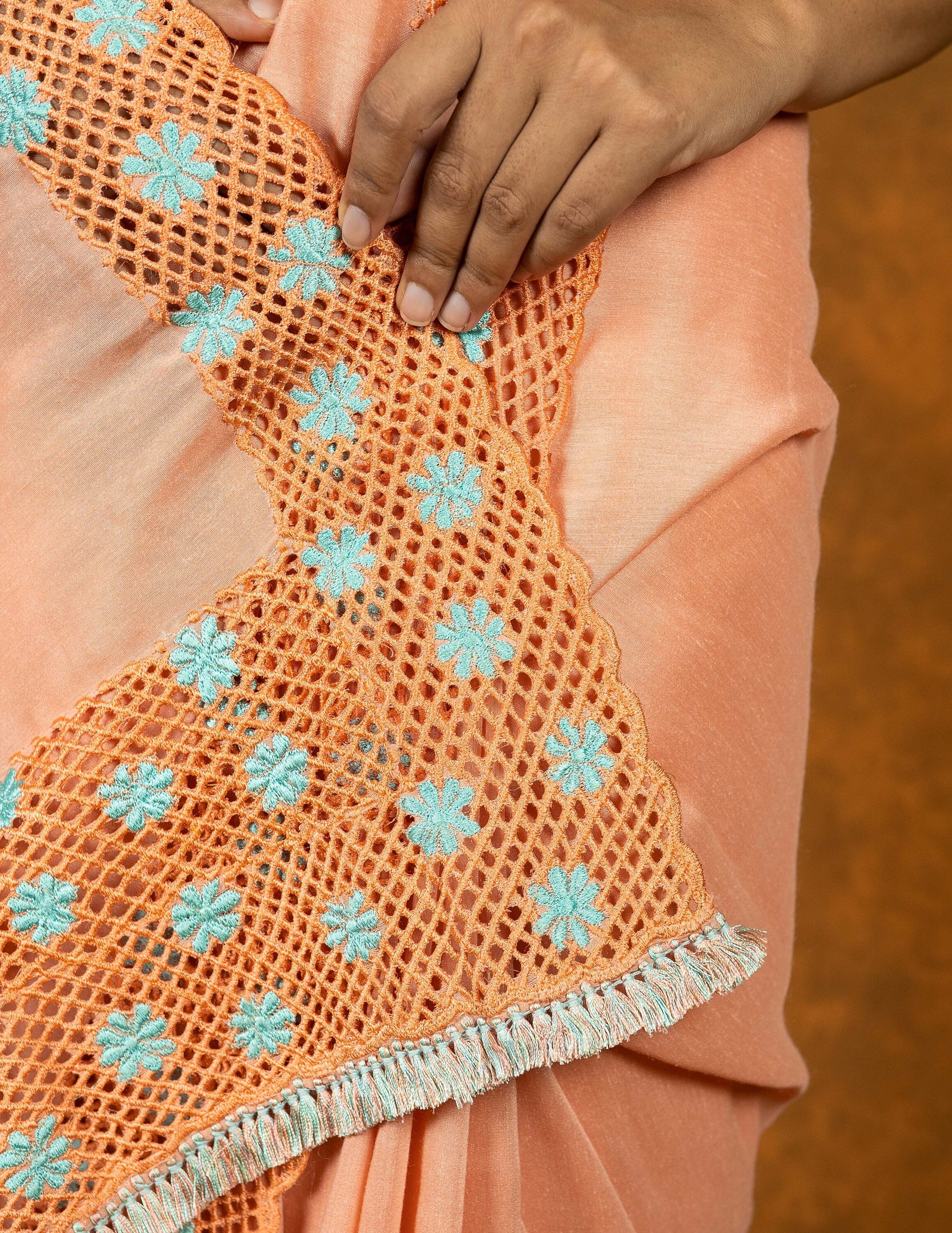 Peach chinnon silk cutwork embroidered saree with tassels