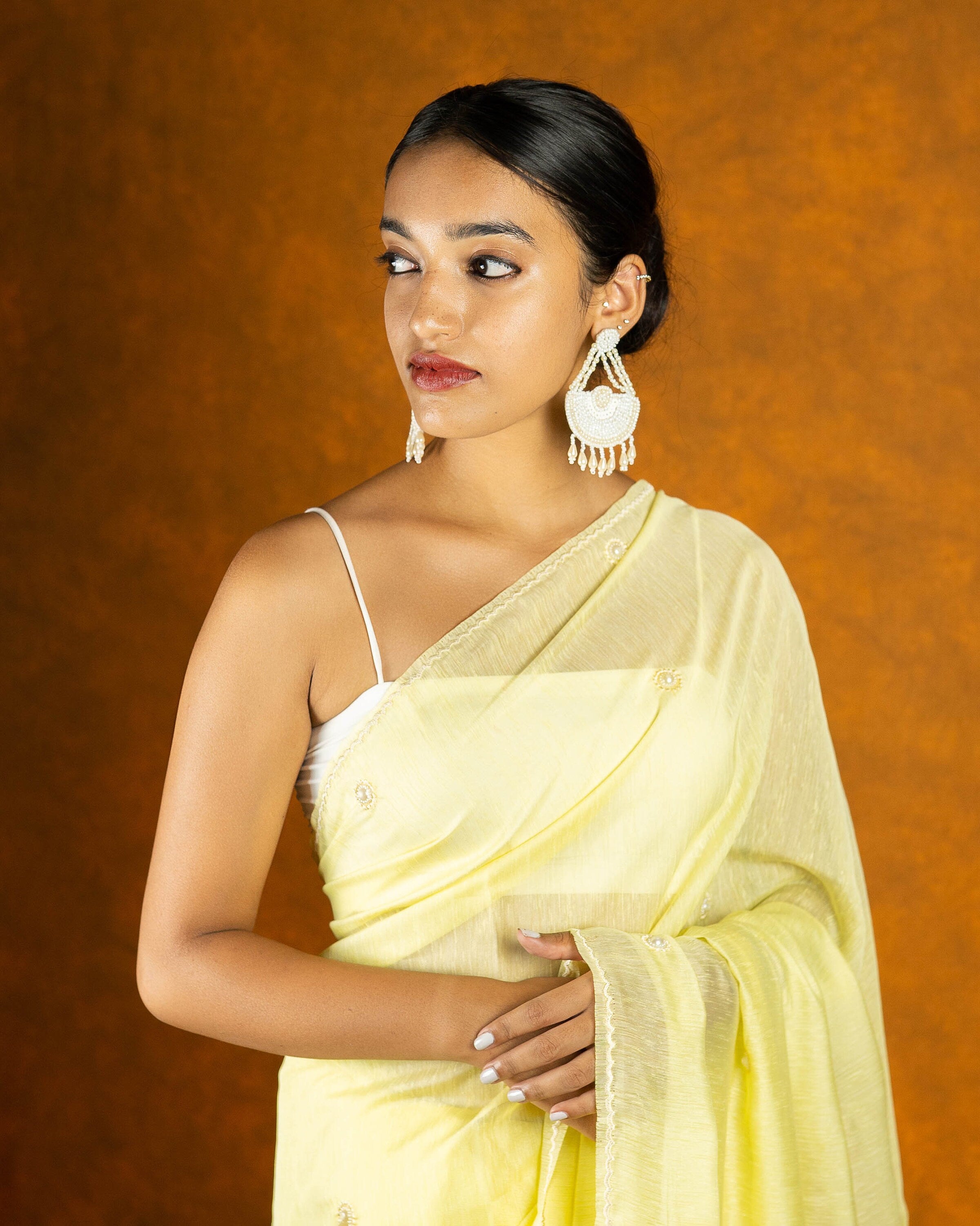 Lemon yellow linen saree with pearl work,