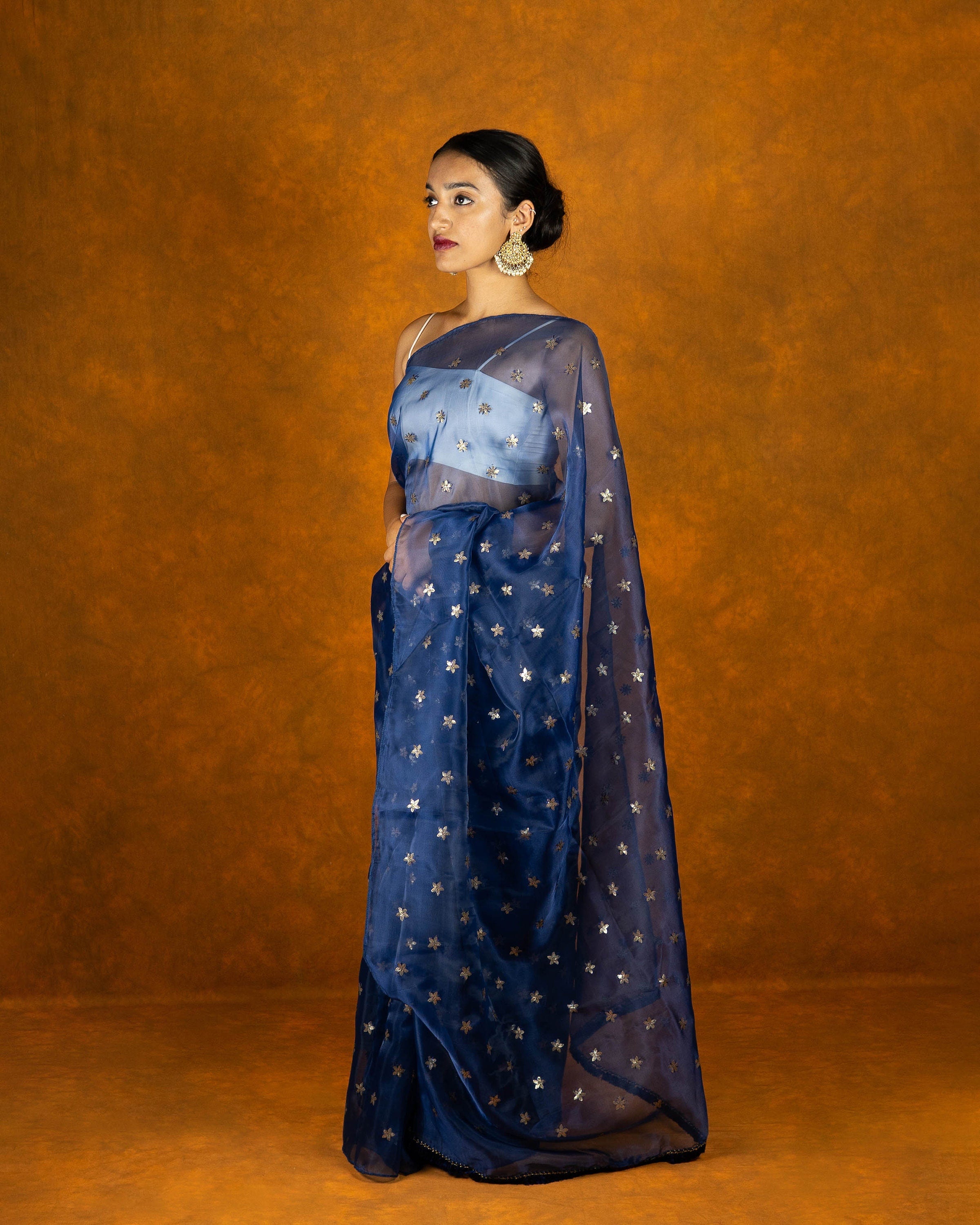 Royal blue Organza blend embroidery saree with gold work border and tassels