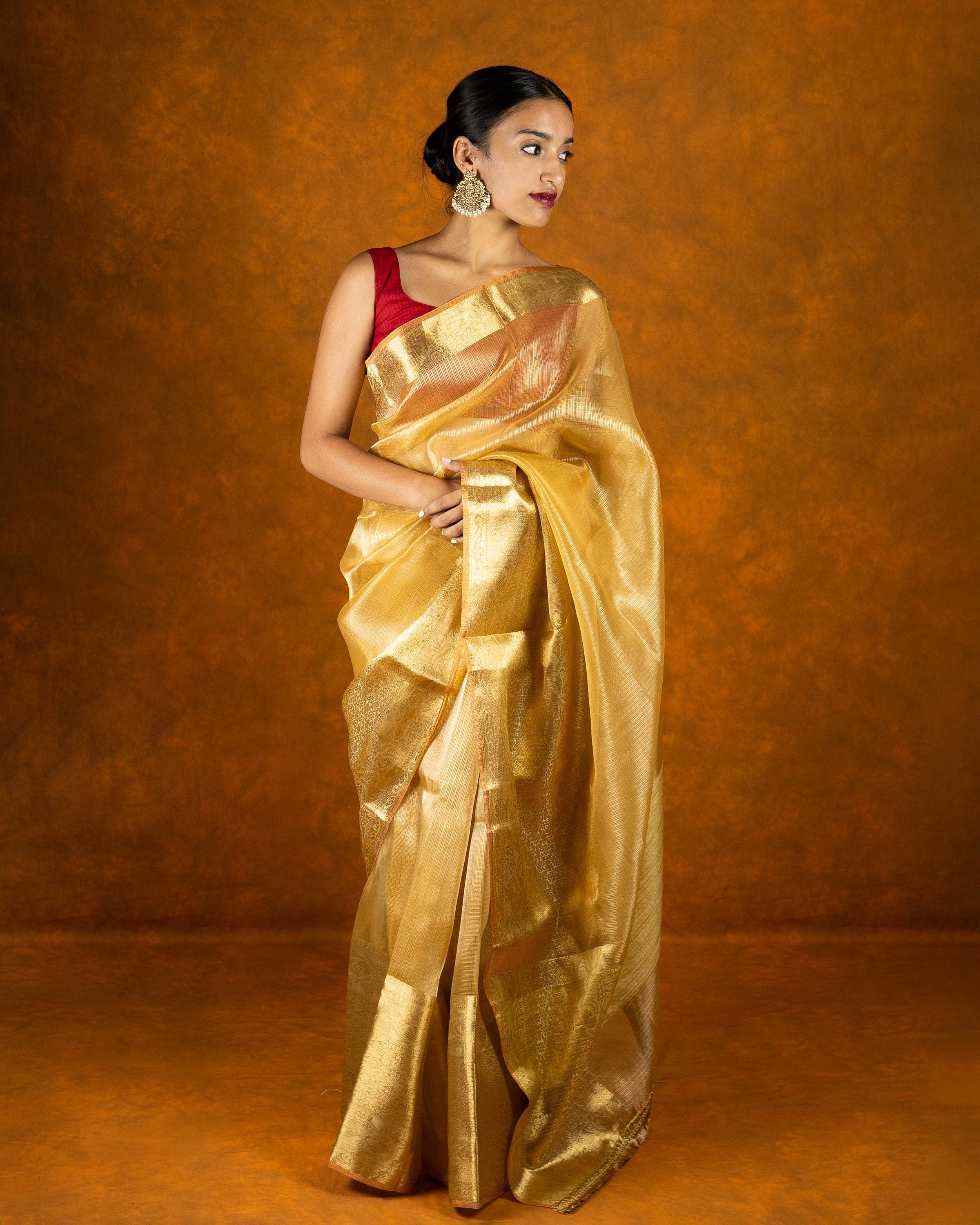 Gold jute silk saree with stone work border and tassel