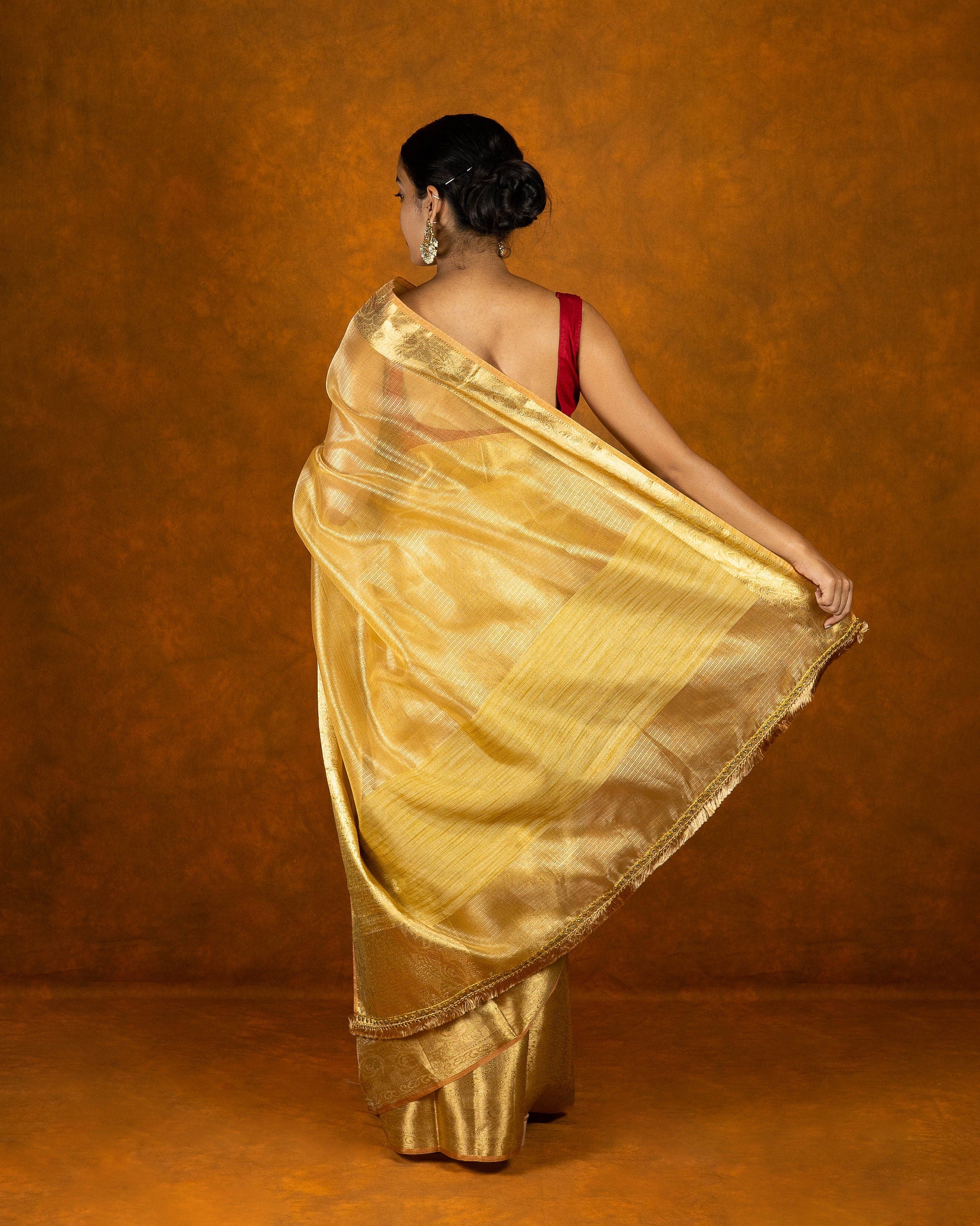 Gold jute silk saree with stone work border and tassel