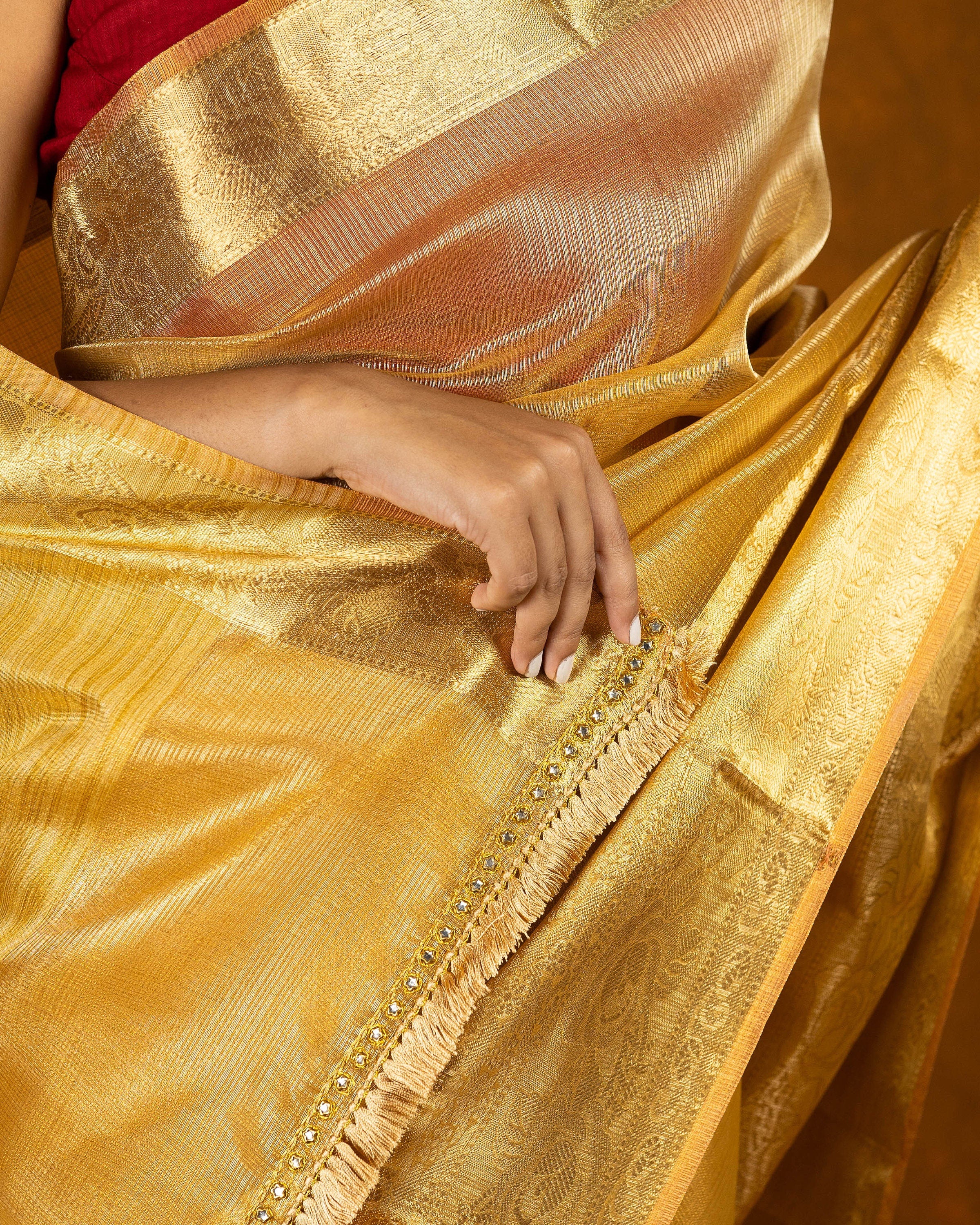 Gold jute silk saree with stone work border and tassel