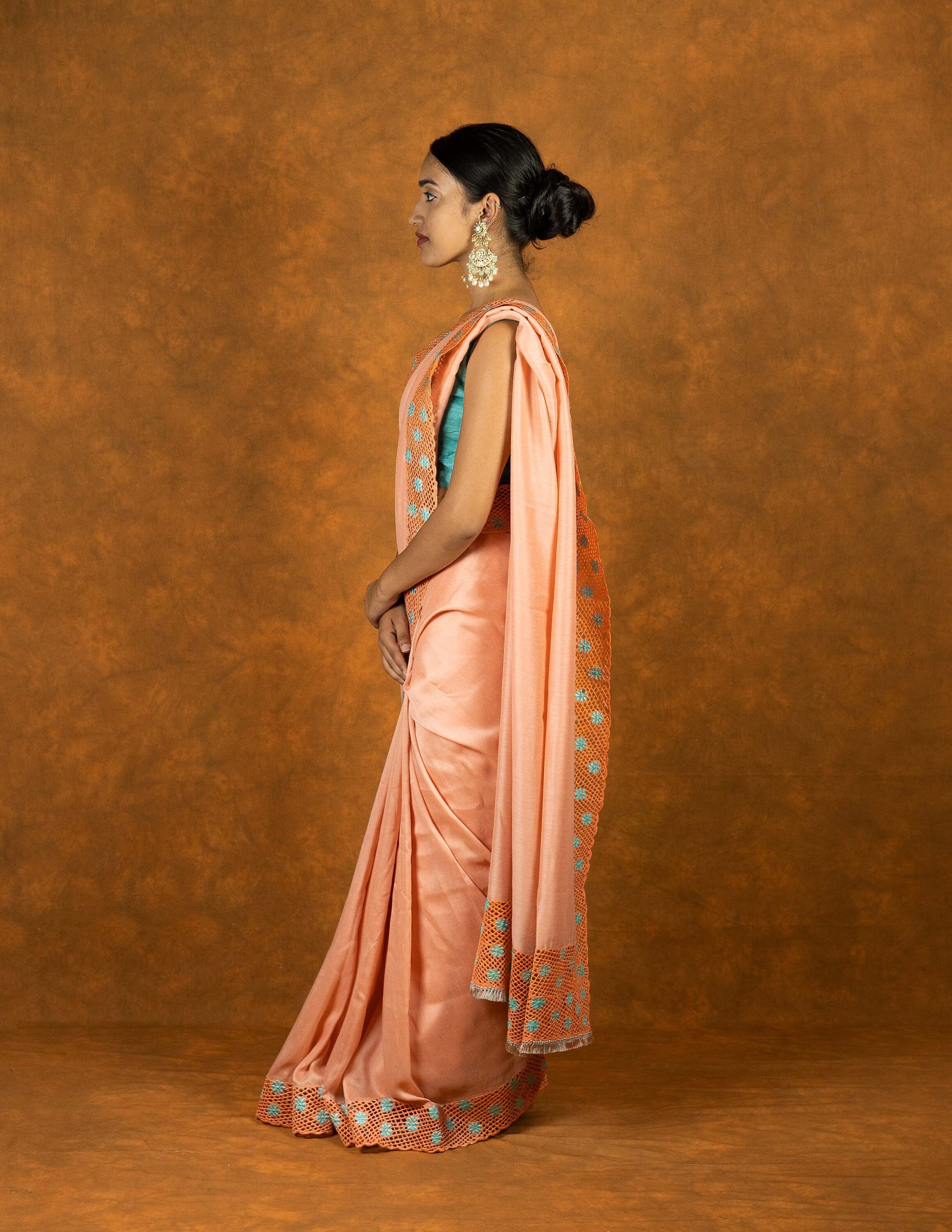 Peach chinnon silk cutwork embroidered saree with tassels