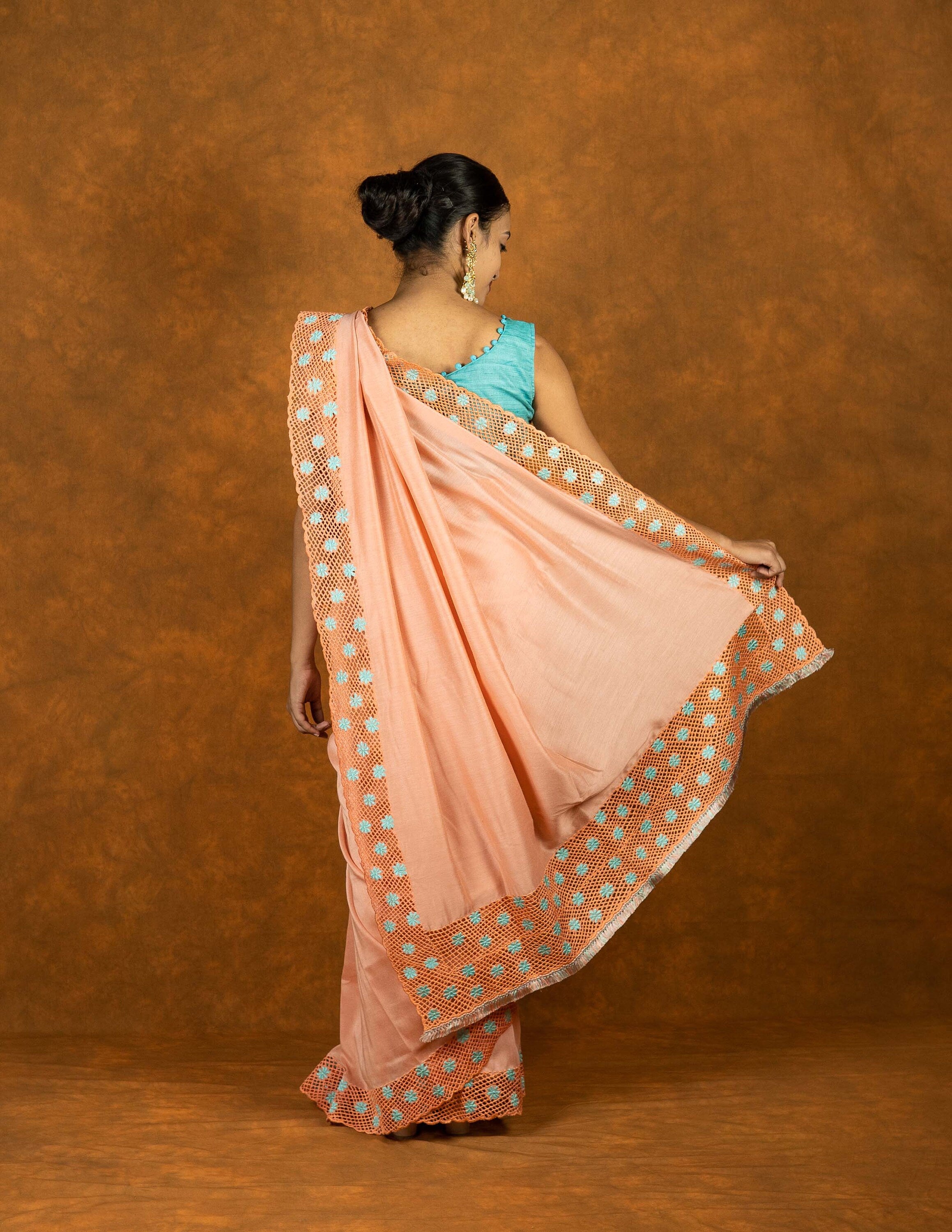 Peach chinnon silk cutwork embroidered saree with tassels