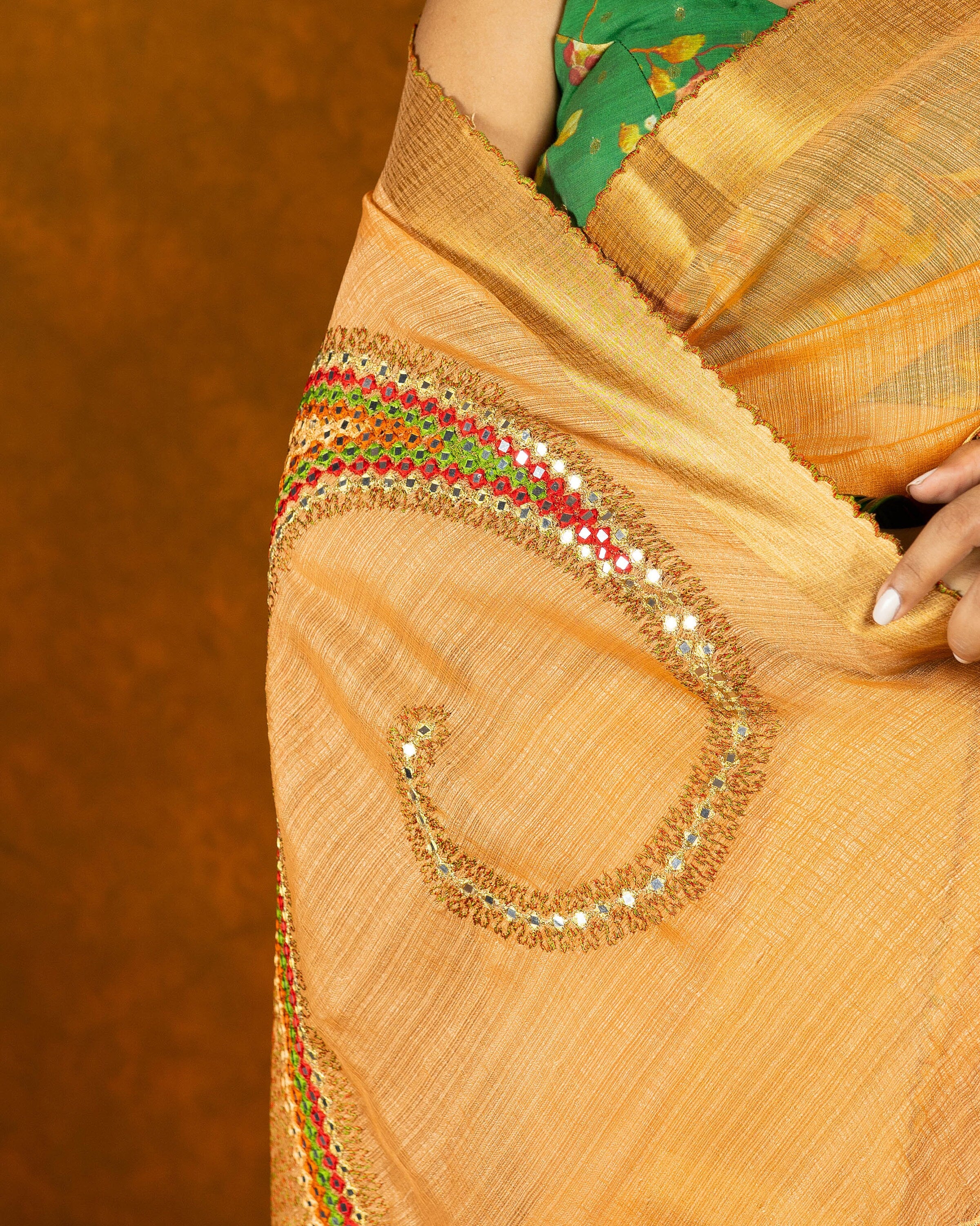 Peach Orange embroidery mirror-work saree with gold border and tassels