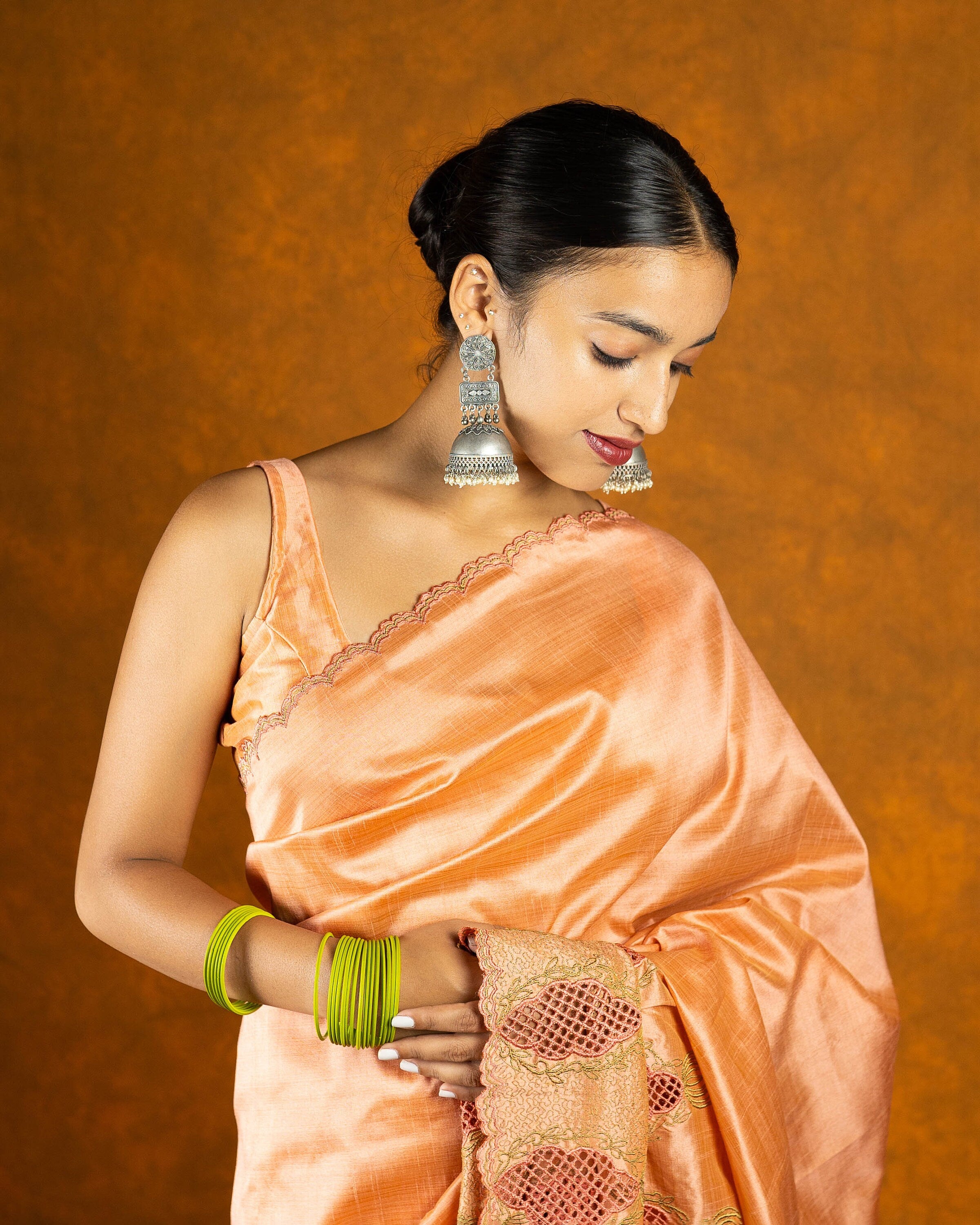 Peach cutwork embroidery saree with tassels