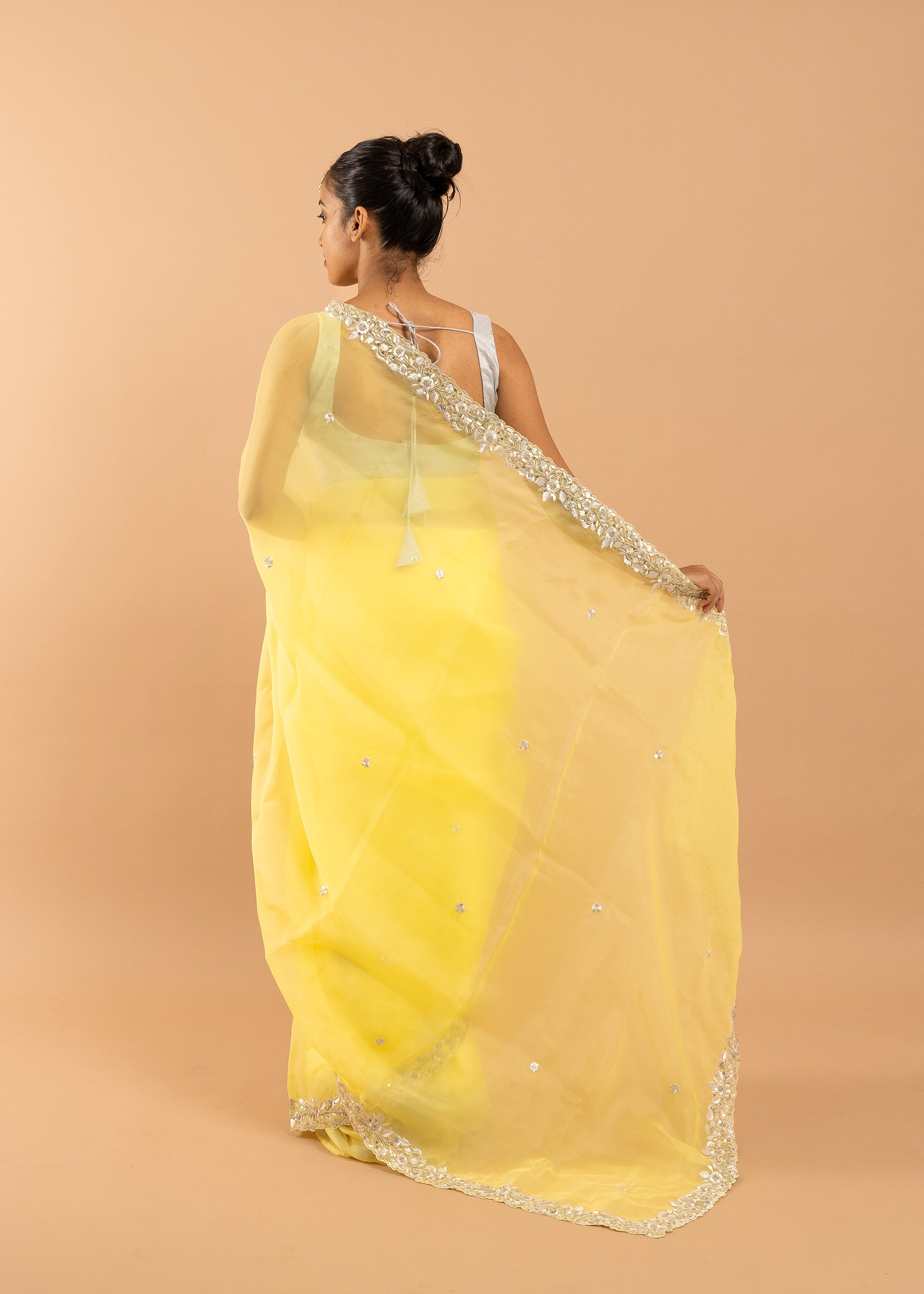 Yellow organza saree with zari silk thread  and beads handwork embroidery